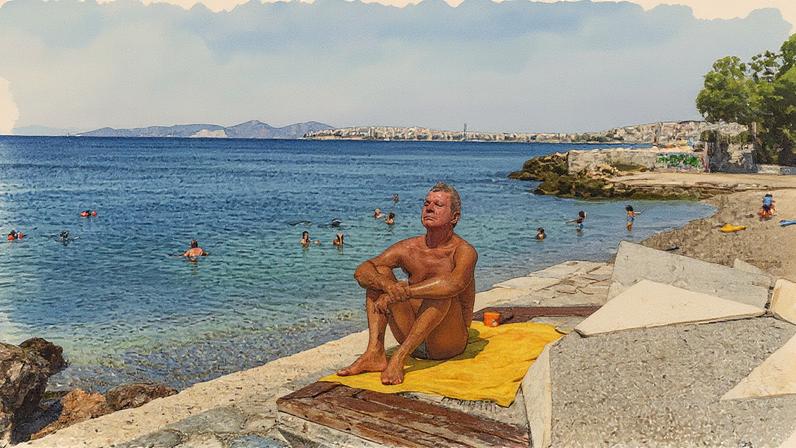 Homem aproveita a praia em Atenas, na Grécia, durante onda de calor com temperaturas de até 45,8°C (Foto: Reprodução)