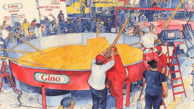 Equipe de Hilda Baci utiliza espátulas gigantes para mexer uma grande quantidade de arroz em uma panela enorme (Foto: Reprodução)