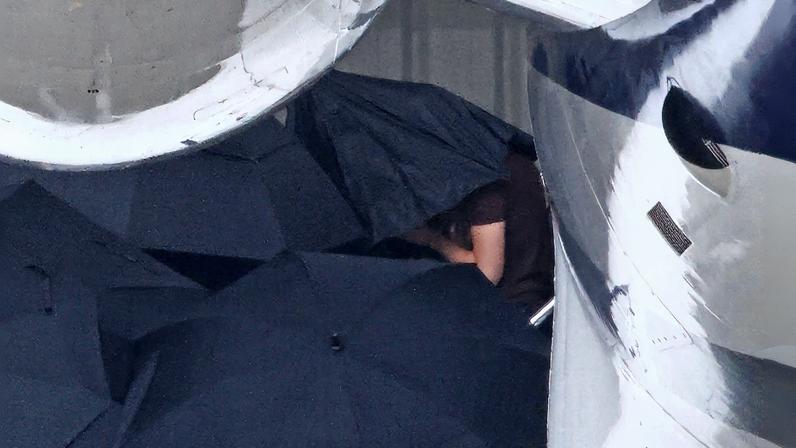 Taylor Swift arrived in Santa Barbara on Friday for Selena Gomez's wedding to Benny Blanco, under the cover of a cluster of umbrellas. B-TEAM / BACKGRID