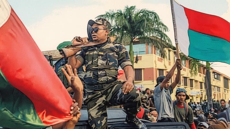 Soldiers from Madagascar’s elite Capsat unit gather with protesters after announcing they will refuse any orders to shoot demonstrators.