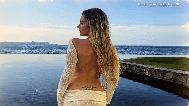 Lottie flaunted her lower back tattoo in a backless Outcast crop top paired with a matching low-slung maxi skirt. lottiemossxo/Instagram