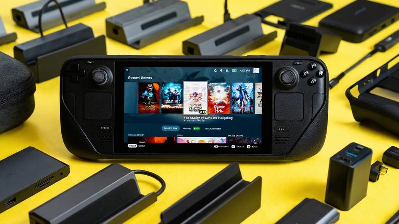 A Steam Deck in a protective case, propped up on a yellow table amid various accessories made by Jsaux.