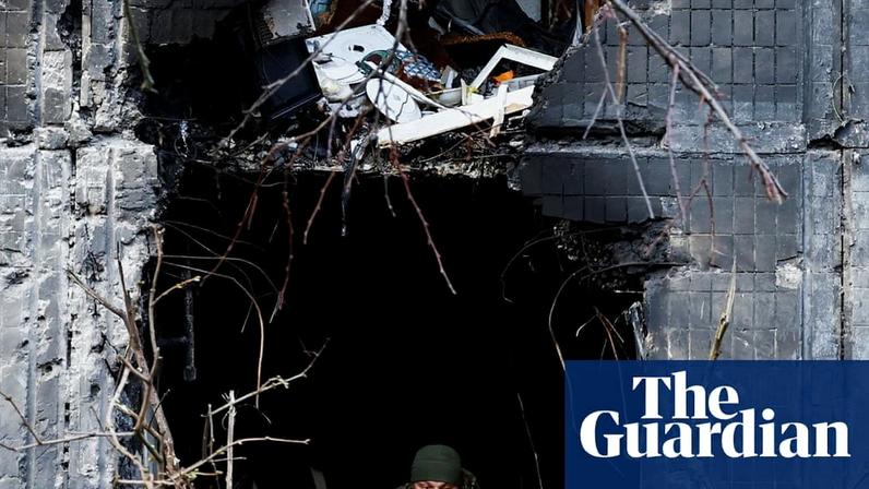 An investigator looks through the window of Kyiv, Ukraine, in the aftermath of Russia’s drone and missile strikes that killed at least six people. Photograph: Thomas Peter/Reuters