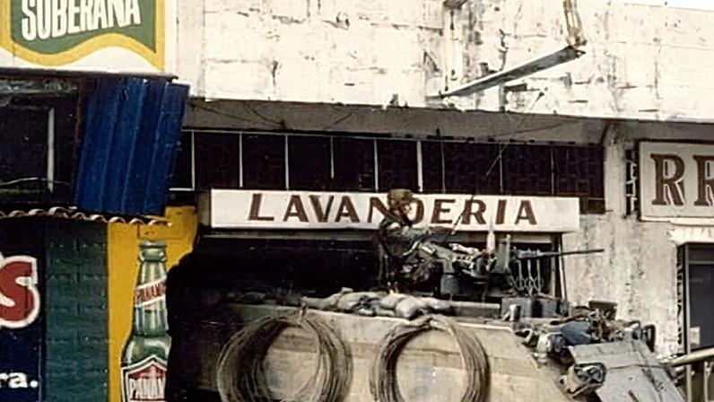 An American M113 armoured personnel carrier takes guard outside a laundry in Panama City during the second day of Operation Just Cause in December 1989.