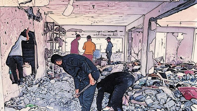 Palestinians in Gaza City clear debris from a building damaged by the Israeli strikes.