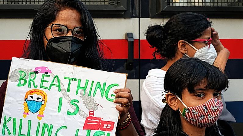 A woman holds a placard during a protest against the hazardous air pollution situation in New Delhi, India