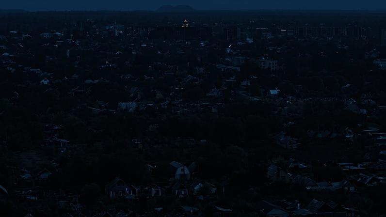 The city of Pokrovsk, Ukraine, shrouded in fog, where destroyed homes and buildings seem to be abandoned among the city's trees following intense fighting.