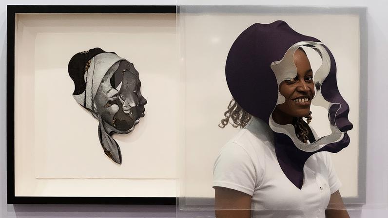 A visitor to Kó Gallery’s stand, with works by Mobolaji Ogunrosoye, at the 2024 edition of Art X Lagos; Photo © Kevwe Eru, courtesy Art X Lagos