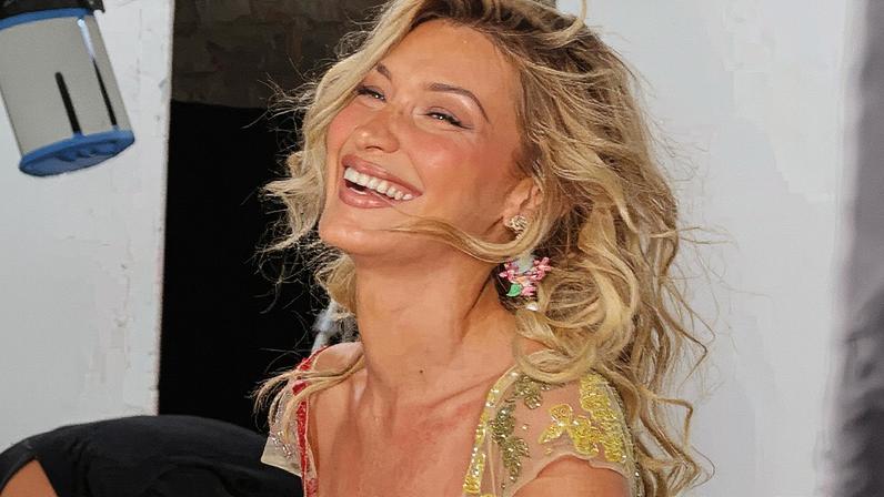 Bella Hadid chose a colorfully beaded sheer dress from celeb-favorite Clio Peppiatt for her latest Orebella campaign. bellahadid/Instagram