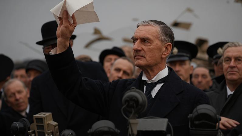 British Prime Minister Neville Chamberlain declares "peace for our time" at Heston Aerodrome in London on his return from negotiations with Adolf Hitler in Munich, Germany.